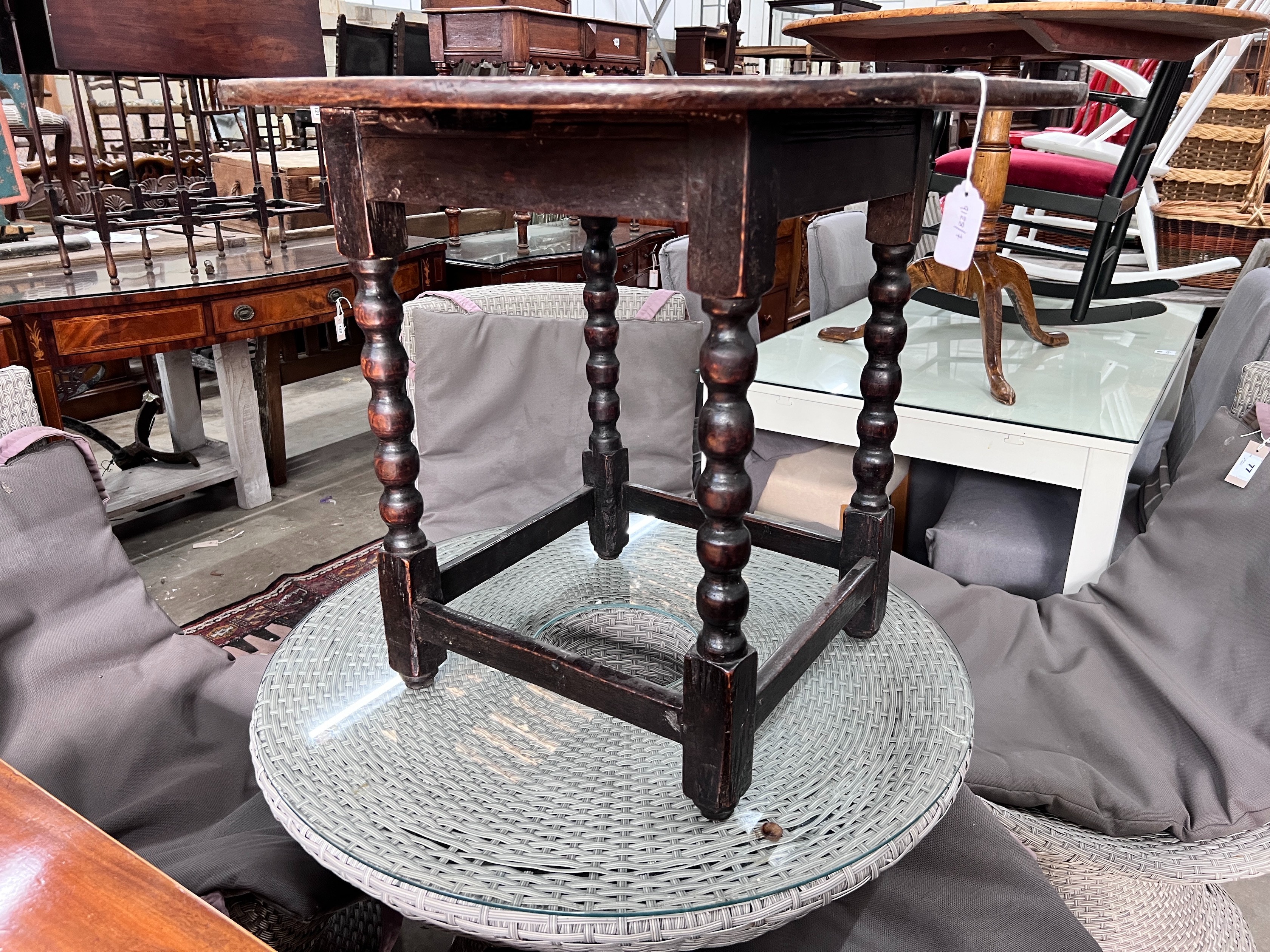A circular oak bobbin legged table, diameter 73cm, height 61cm *Please note the sale commences at 9am.